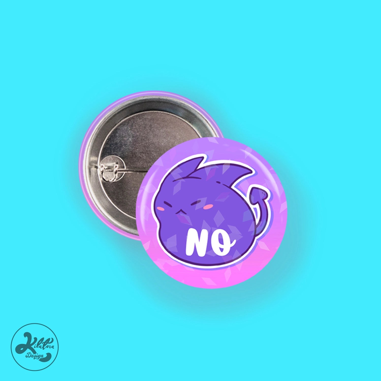 38mm button pin by Kilatora Design. Pink and purple color with broken glass holographic effect. Purple devil character Tora and white text no.