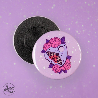 59mm magnet by Kilatora Design. Light purple color with purple ouija, a moth with white and orange wings and lilac flowers.