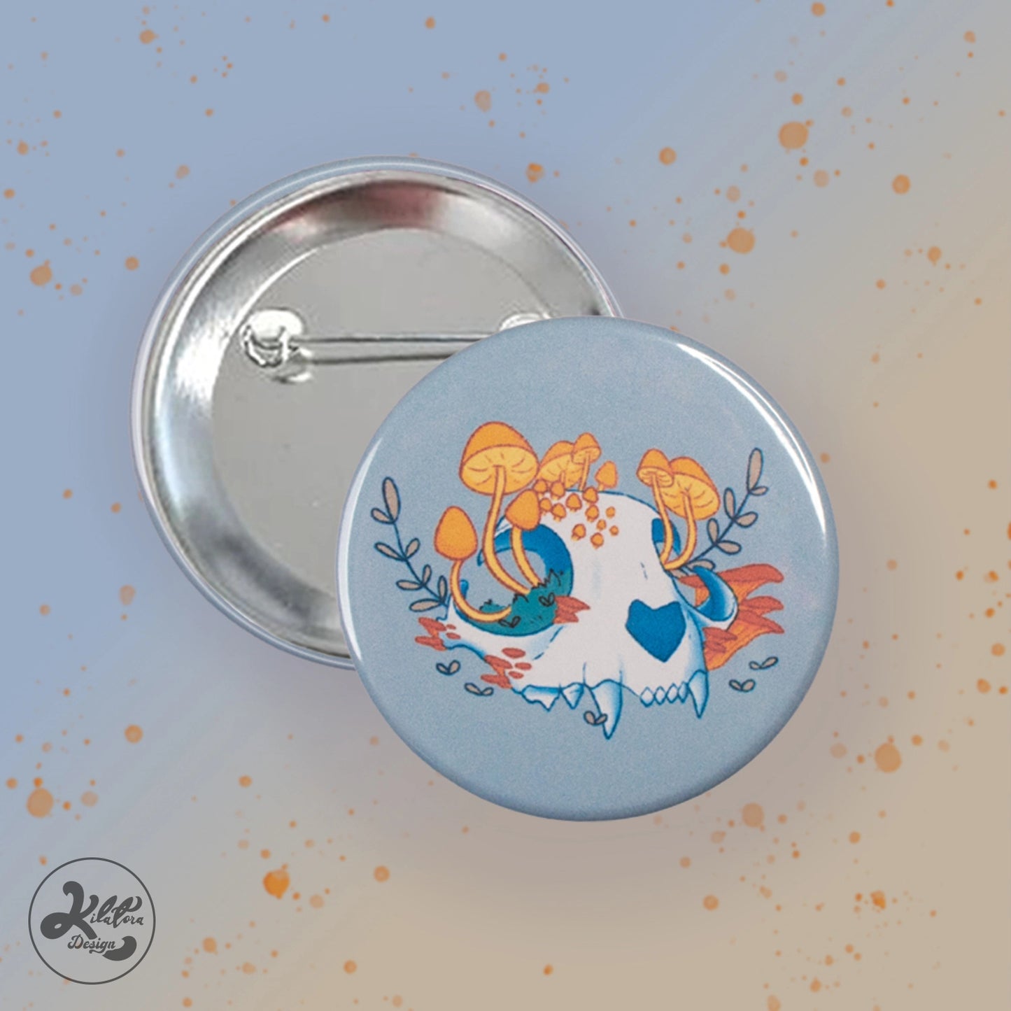 59 mm button pin by Kilatora Design. Light grey color with a white cat skull with yellow mushrooms and plants growing from it.