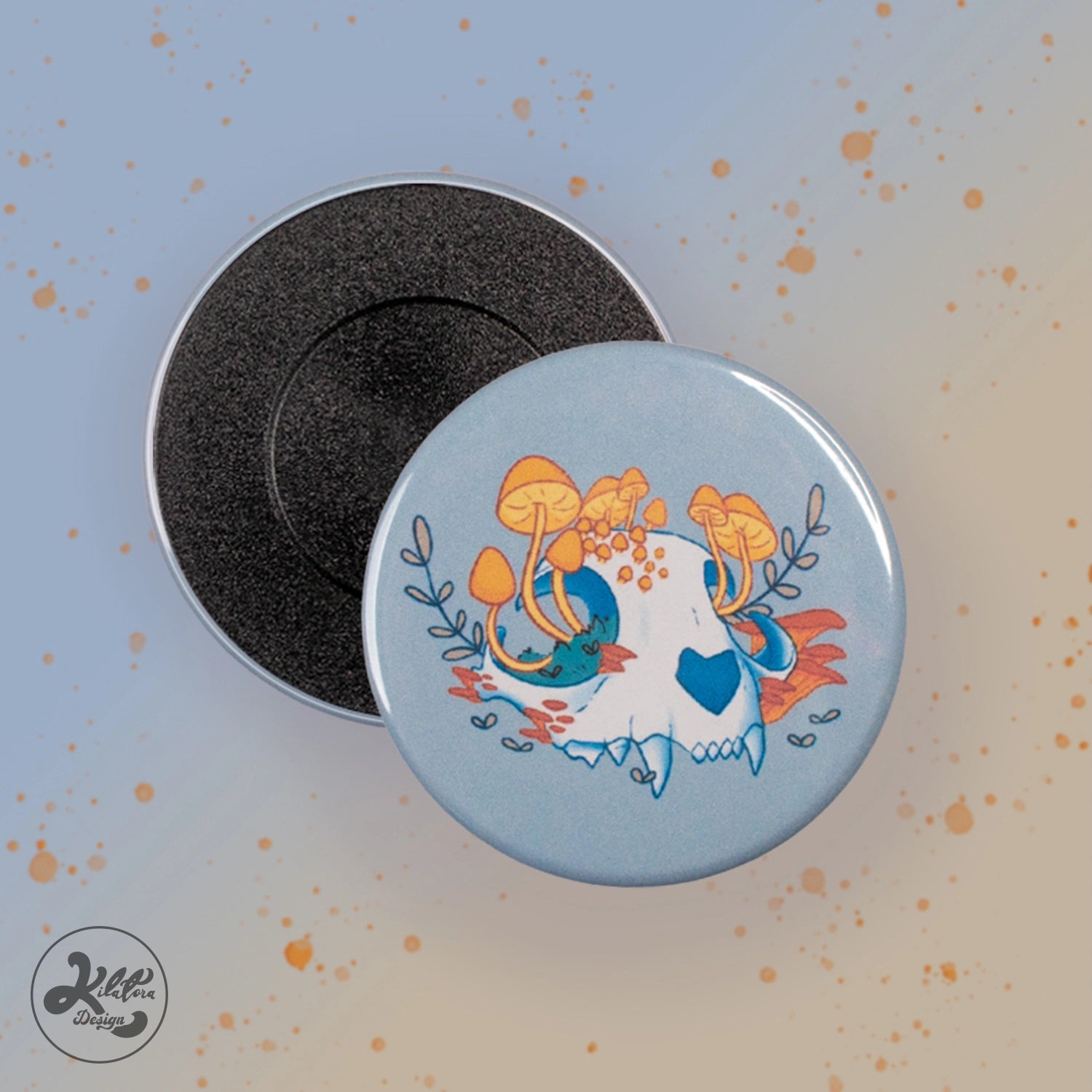 59 mm magnet by Kilatora Design. Light grey color with a white cat skull with yellow mushrooms and plants growing from it.