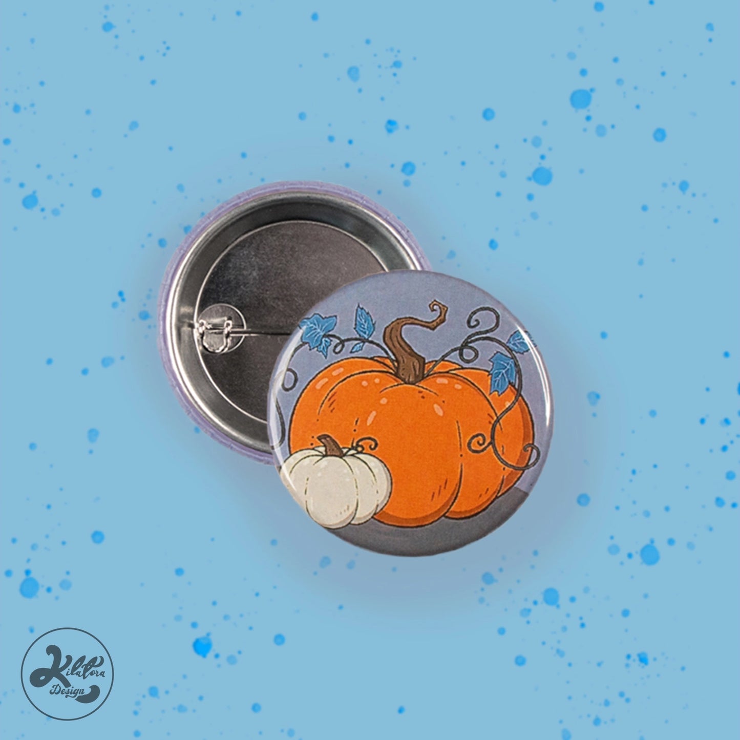 38mm button pin by Kilatora Design. Grey color with one big orange pumpkin and one small white pumpkin.
