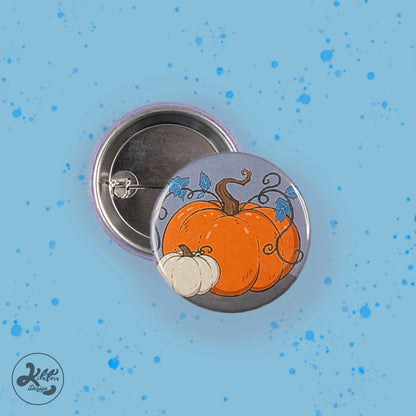 38mm button pin by Kilatora Design. Grey color with one big orange pumpkin and one small white pumpkin.