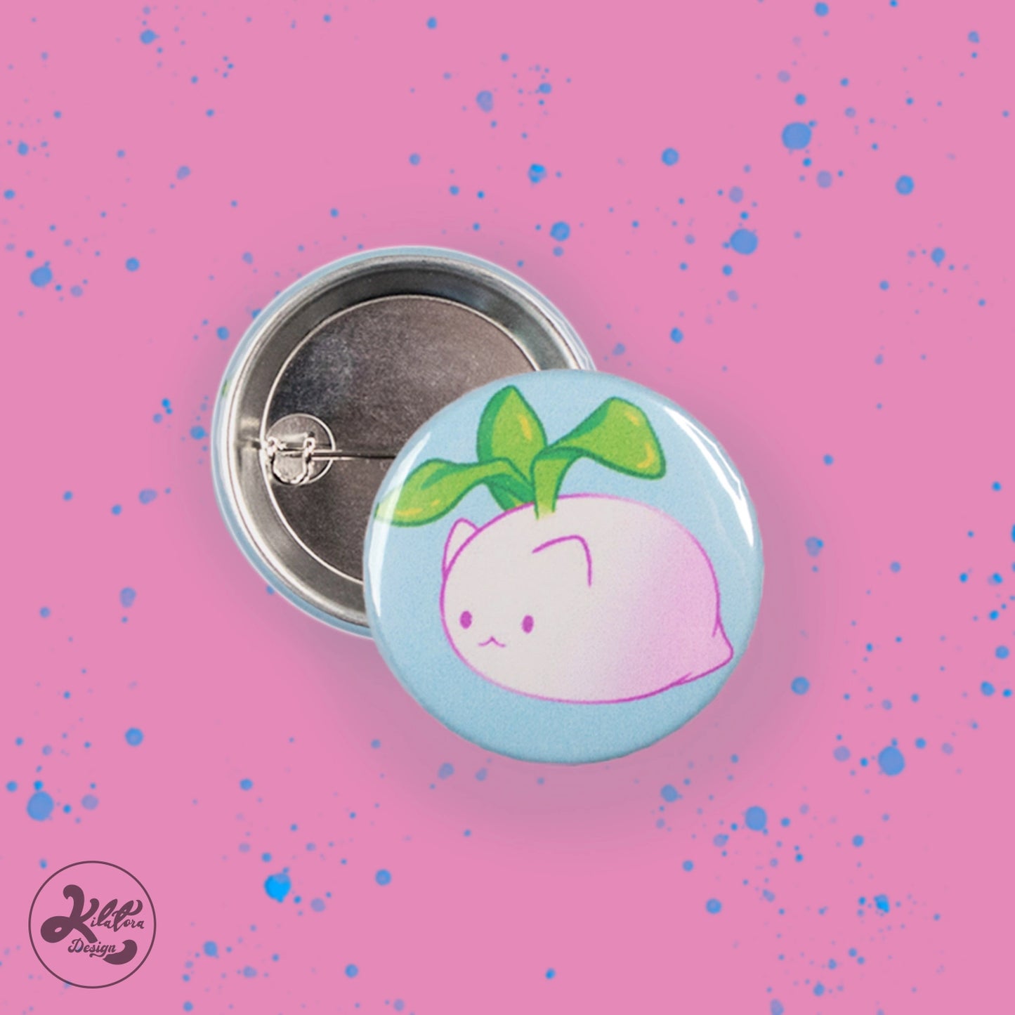 38mm button pin by Kilatora Design. Light blue color with white and pink turnip cat with green leaves.